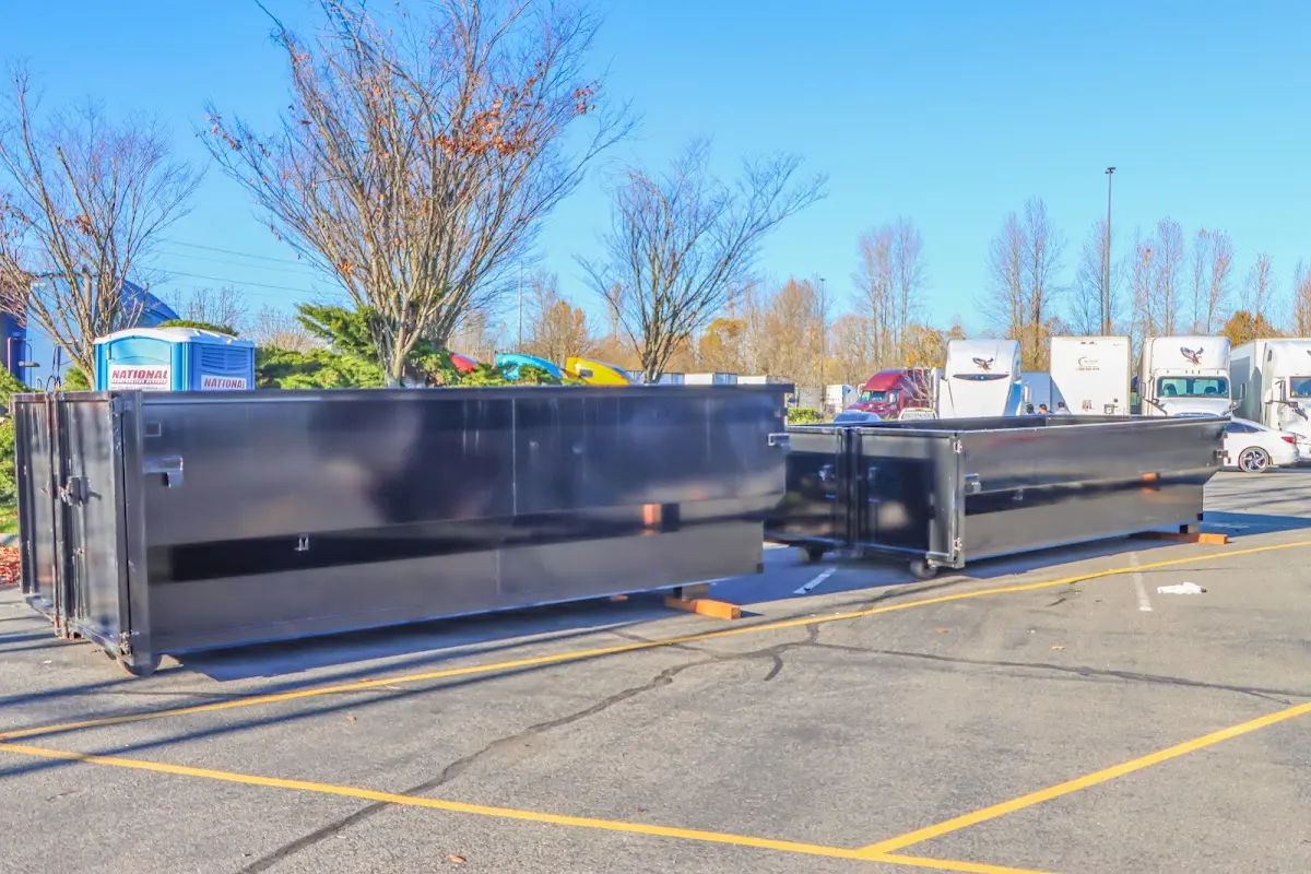 Professional dumpster rental service with roll-off container on residential driveway in Glenmont